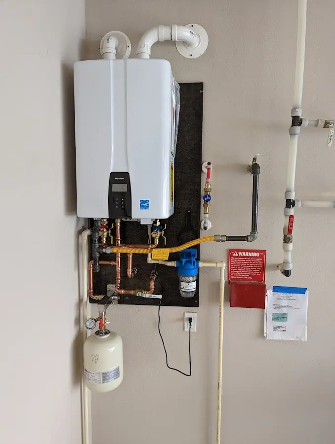 Professional plumber installing copper piping in a McDonough home